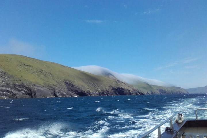 a body of water with a mountain in the background