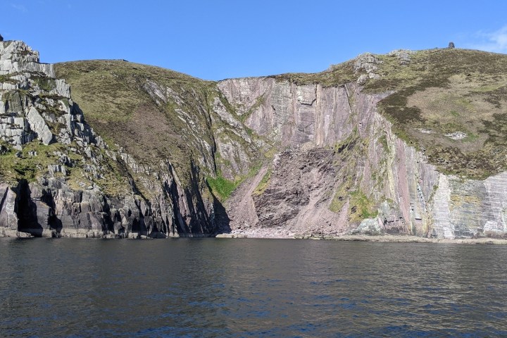 a rocky island in the middle of a body of water