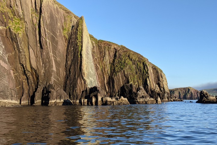 a body of water with a mountain in the background