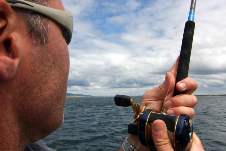 a man holding a fishing rod