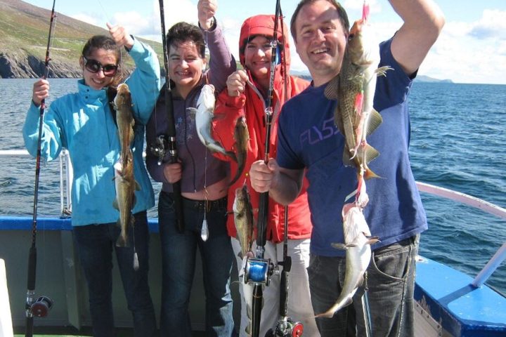 a group of people standing on a boat posing for the camera