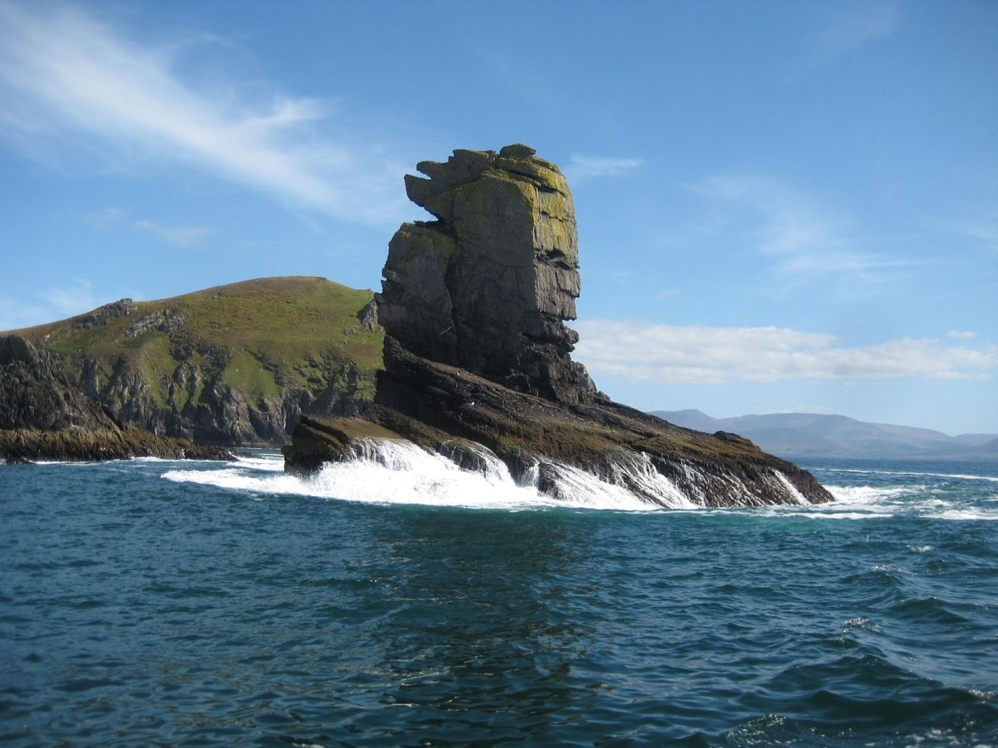 a large body of water with a mountain in the background
