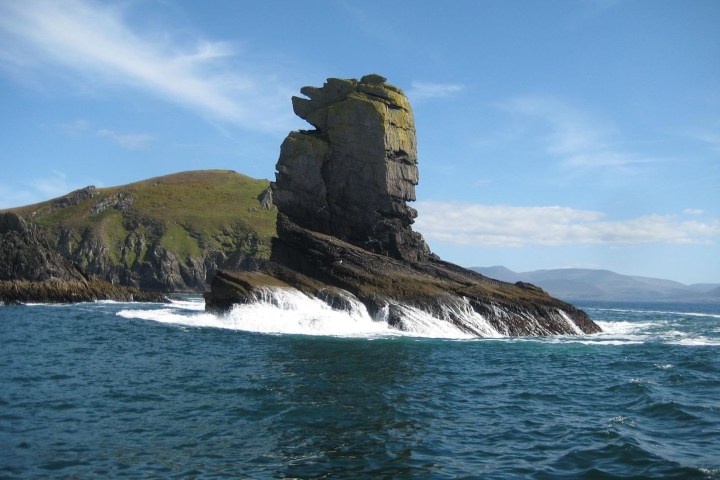 a large body of water with a mountain in the background