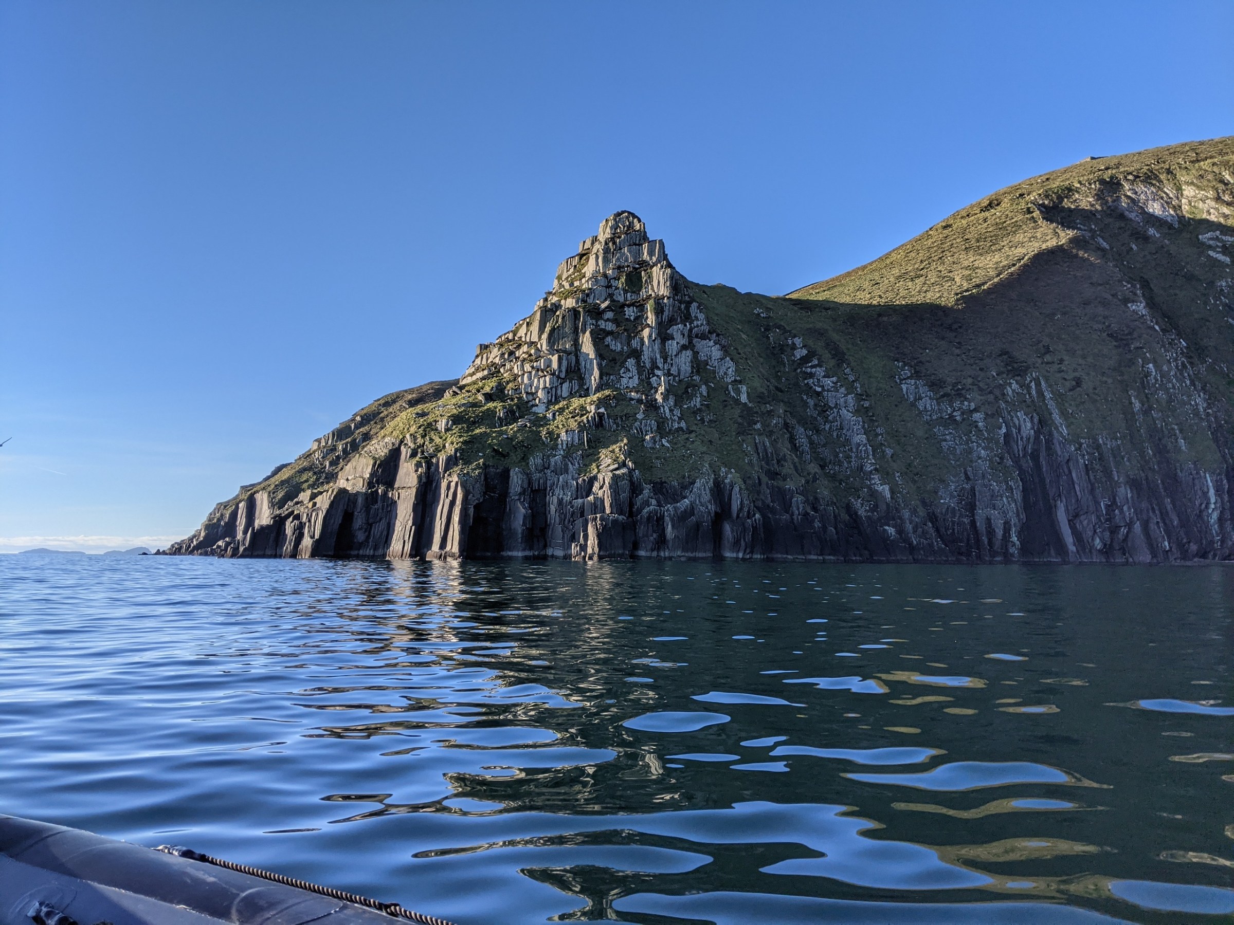 a body of water with a mountain in the background