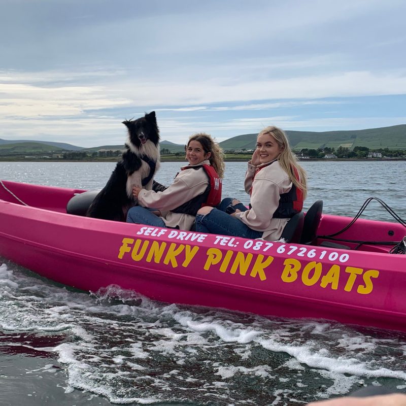a person riding on the back of a boat in a body of water