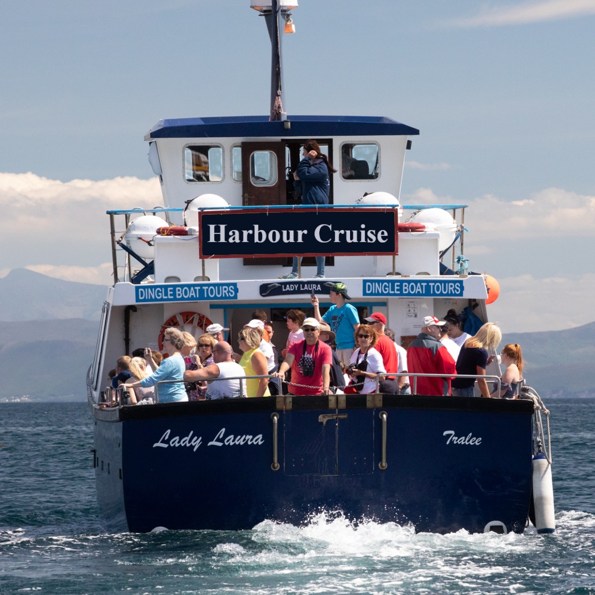 a group of people riding on the back of a boat in the water