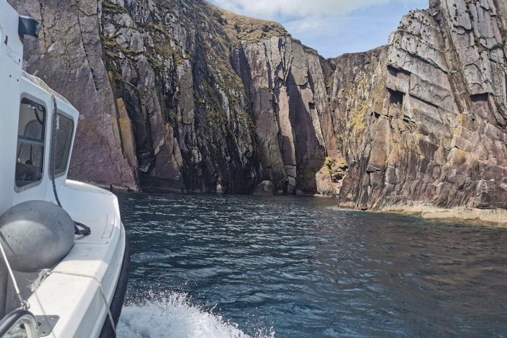 a rocky cliffside seen from the boat