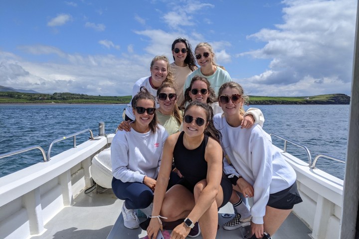 a group of people on a boat posing for the camera