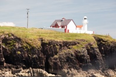 a large body of water with a mountain in the background