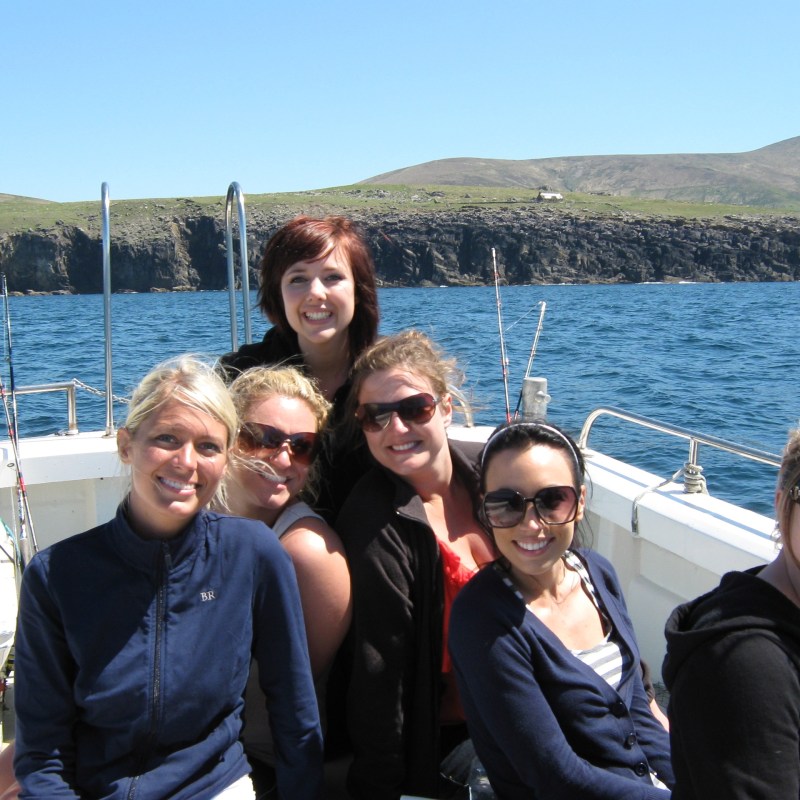 a group of people posing in front of a body of water
