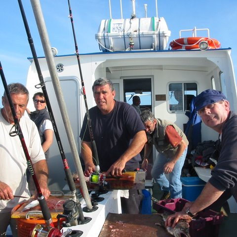 a group of people standing on a boat