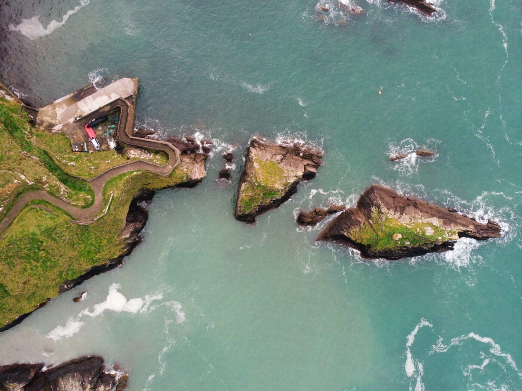 a body of water with rocky islands in it