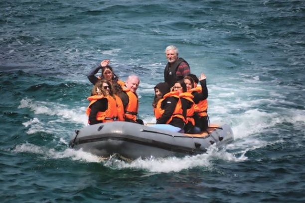 a group of people on a raft in a body of water