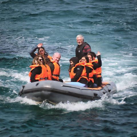 a group of people on a raft in a body of water
