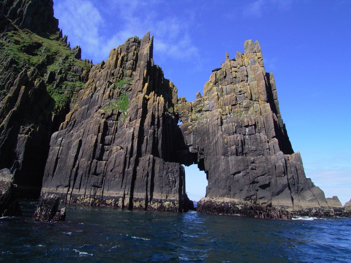 a close up of a large rock next to water