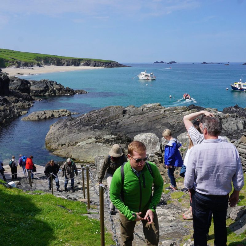 a group of people standing next to a body of water