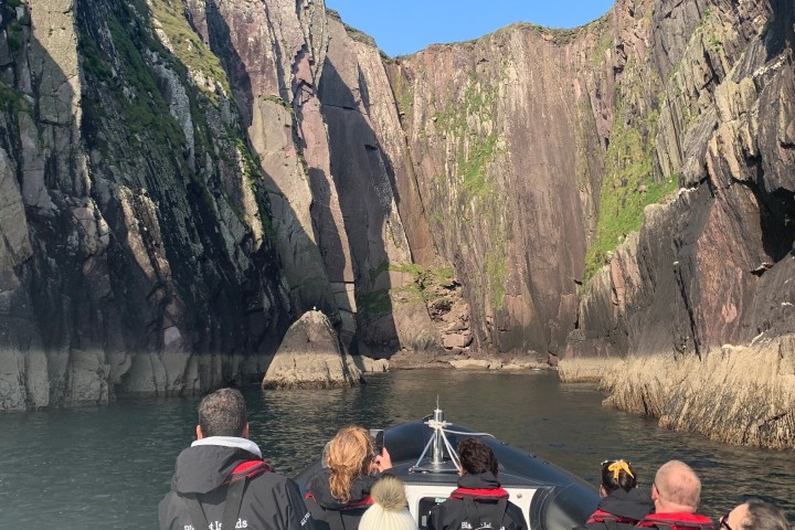a group of people sitting on a rock