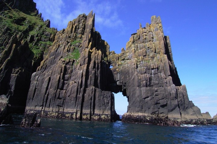 a close up of a large rock next to water
