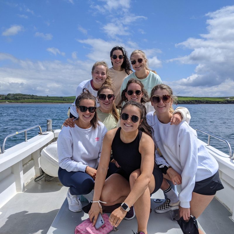 a man and a woman standing in front of a body of water