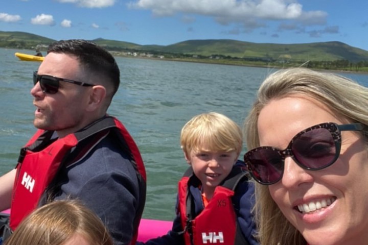 a group of people standing next to a body of water